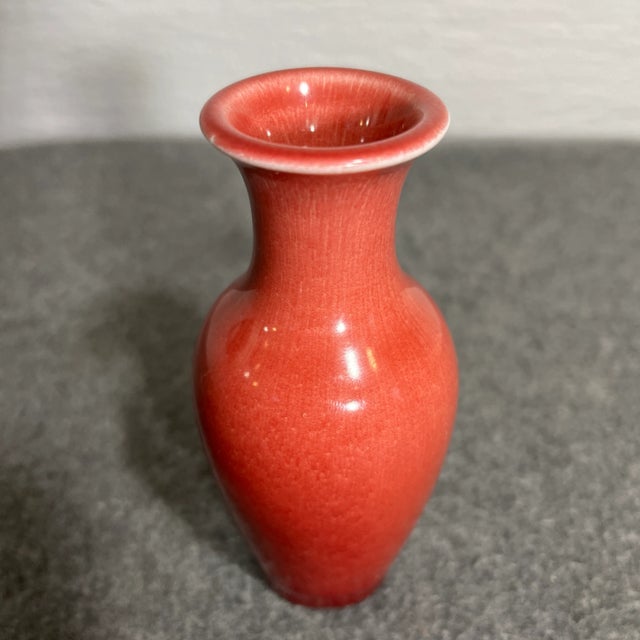 Glossy finish vessel with slightly flared neck, designed in a red coloration. Rookwood backstamp. C.1932