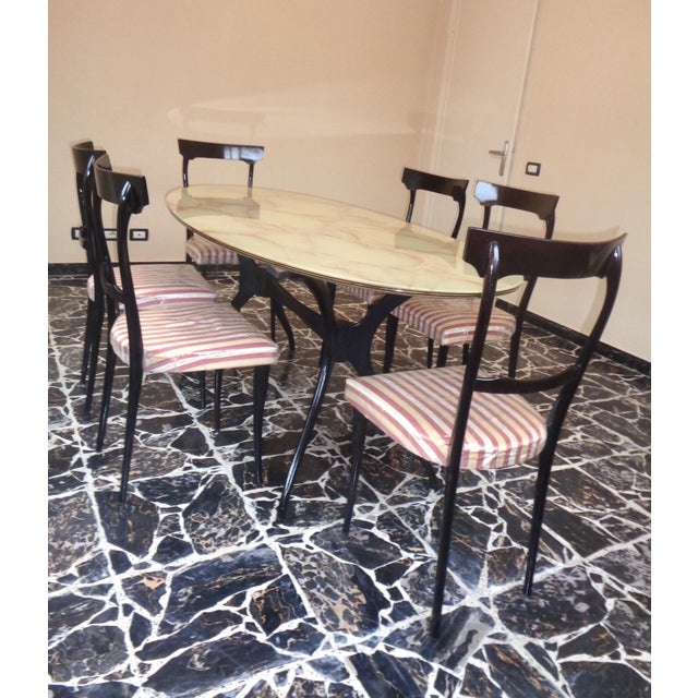 This set consists of the beautiful elegant oval table and six chairs, all with thin curved legs in lacquered ebonized...