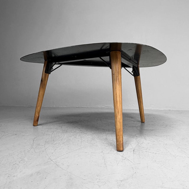 Vintage wooden coffee table, probably originating from Belgium. The table features an organically shaped top with soft,...