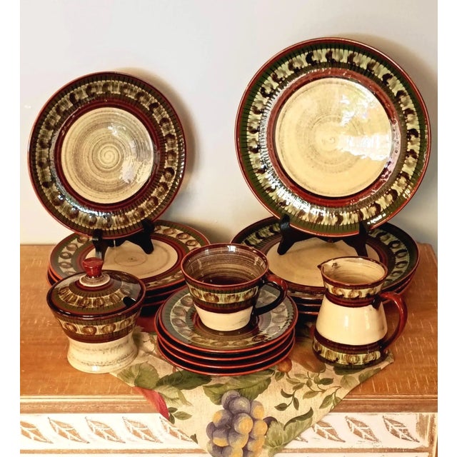 This vintage artisan-crafted red clay stoneware dinnerware service for four brings an earthy, hand-thrown rustic elegance...