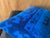 Two sinuous dragon-like forms coil across the upper register in deep navy, flanked by crossed X marks and a four-lobed...