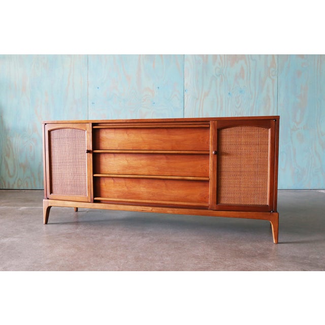 A 1960s dresser cabinet by Lane of Alta Vista Virginia. A part of the Rhythm series this cabinet features a walnut case...