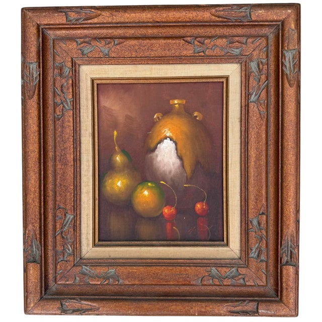 A richly presented vintage still life featuring a signed original oil painting displayed in an exceptional hand-carved...