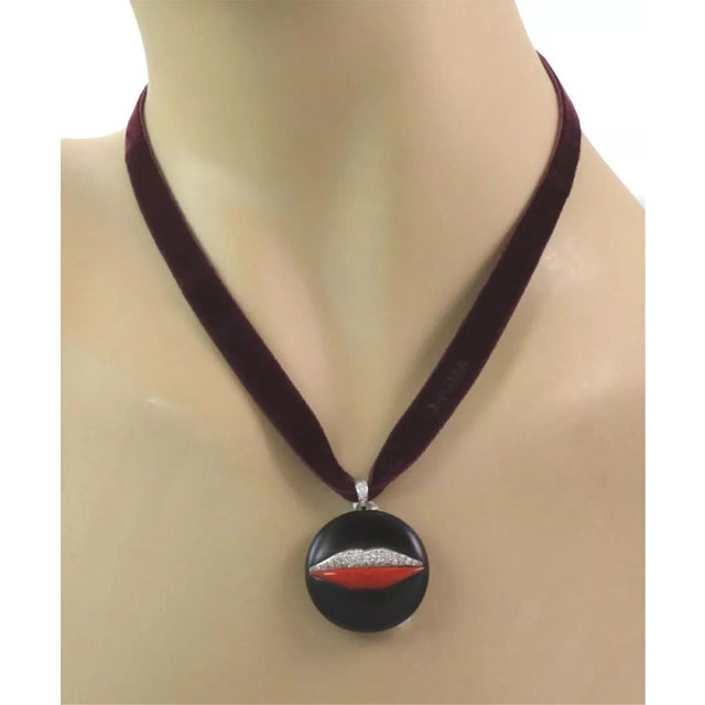 This elegant authentic necklace is by Bvlgari featuring a velvet wide ribbon necklace with a beautiful round pendant...