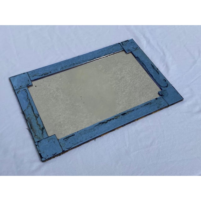 This is a really pretty vintage tray. The entire tray is mirrored with the rim and corners being blue tinted mirror and...