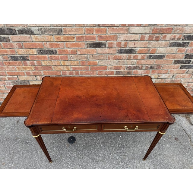 This is unmatched style with this French Louis XV writing desk! It is an Hepplewhite style mahogany writing desk featuring...