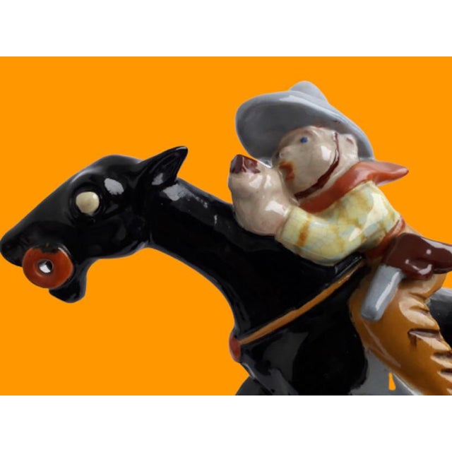 Large hand-painted Komloss statue with characteristic bright colors of a Cowboy hunting on a horse. First series....