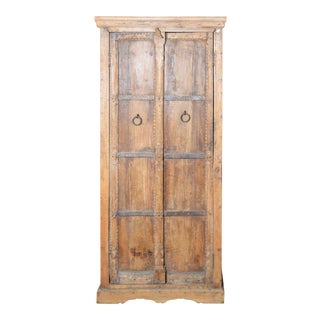 Indian Vintage Wooden Armoire with Metal Braces and Hand-Carved Decor For Sale