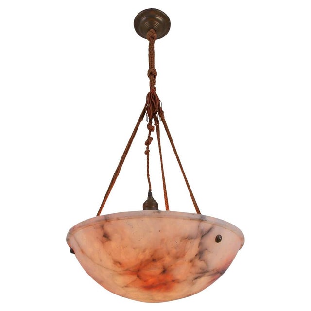 Antique carved pink and white Alabaster Art Deco ceiling light with the original, hand-knotted rope. The pendant spreads a...