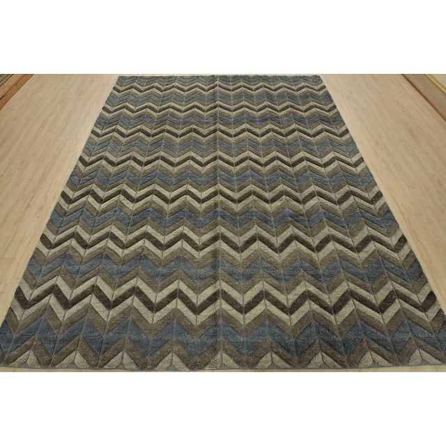 This contemporary geometric Moroccan Chevron rug is hand-knotted with an all-wool pile on a cotton foundation. This rug is...