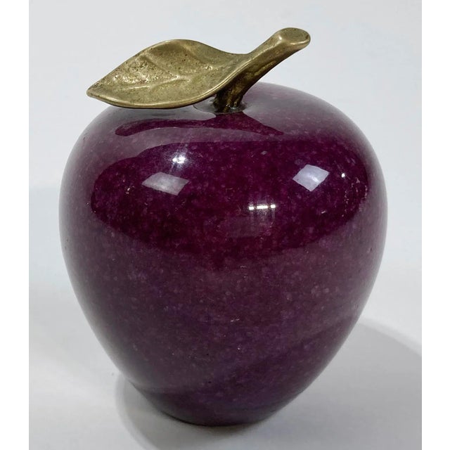 Vintage purple marble paper weight in the shape of an apple with brass stem to top. Age wear. Patina to brass.