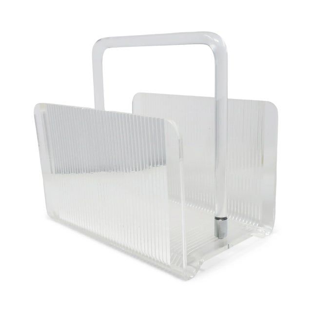 An elegant vintage lucite magazine rack with rounded clear lucite handle. Perfect for storing magazines, books, or records...