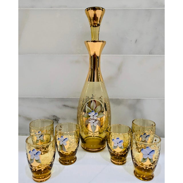 Elevate your barware with this vintage Italian Murano Tre Fuochi amber glass decanter and cordial set, richly decorated...