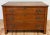 Handsome antique three drawer wood commode. Features rich natural finish with stunning original brass hardware. Three...