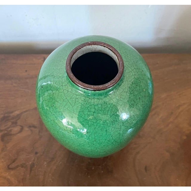 Antique Chinese monochrome green porcelain vase with crackle glaze. Measures 7 5/8" tall x 5" diameter. Good condition.