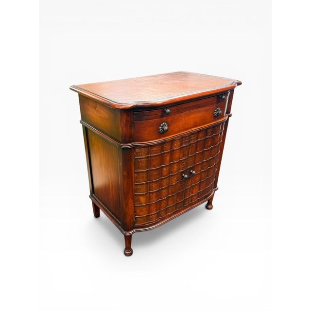 A distinguished English Regency style faux book bar cabinet, thoughtfully crafted in the manner of Theodore...