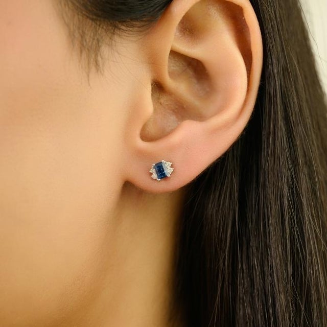 These timeless Art Deco-style stud earrings feature two emerald-cut blue sapphires totaling 0.72 carats, set in solid 14k...