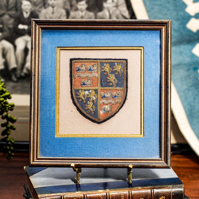 Add a touch of heritage and academic charm to your space with this preppy antique English School Crest, beautifully framed...
