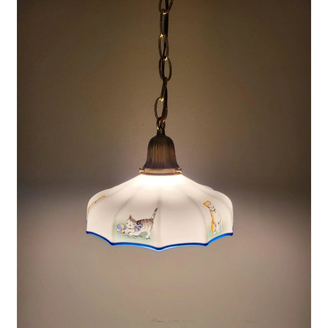 This cute little milk glass pendant is adorned with sweet little dogs and cats around the rim. But the real star of the...