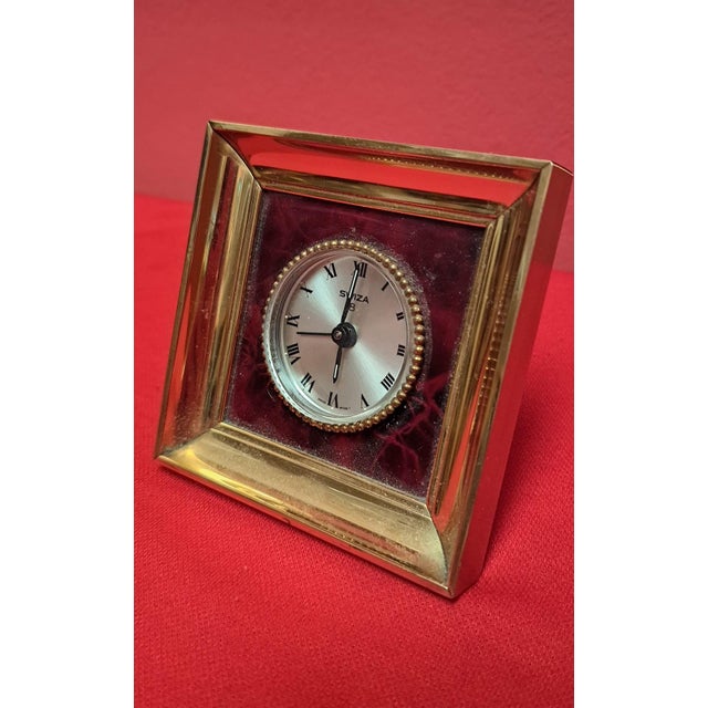 Swiss-made table alarm clock from the 1960s. This refined model is distinguished by its striking, textured, solid brass...