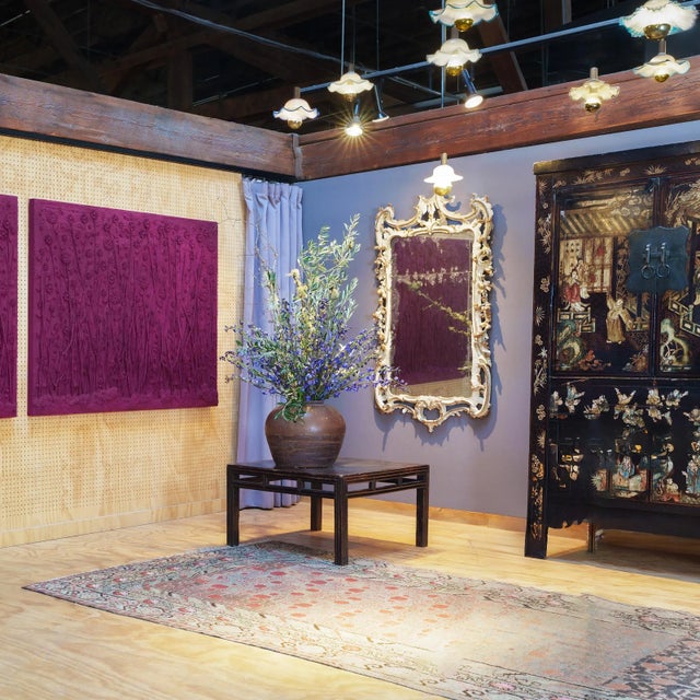 This early 20th century elmwood square table from China's Shanxi province features a floating panel top and an apron...