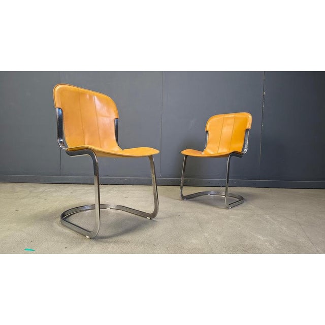 Set of 6 dining chairs by Cidue The chairs have a beautifully shaped chrome frame and come with the original brown leather...