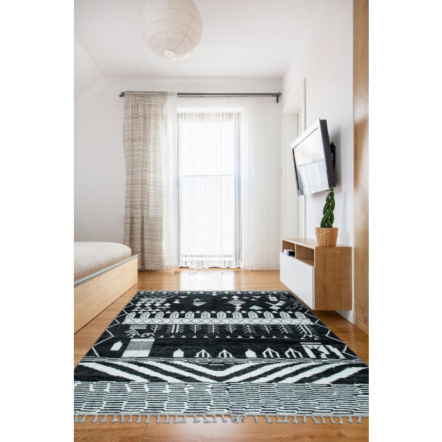 Marrakech Essence Black Berber Carpet, Country of Origin: Pakistan. This striking hand-knotted piece offers a...