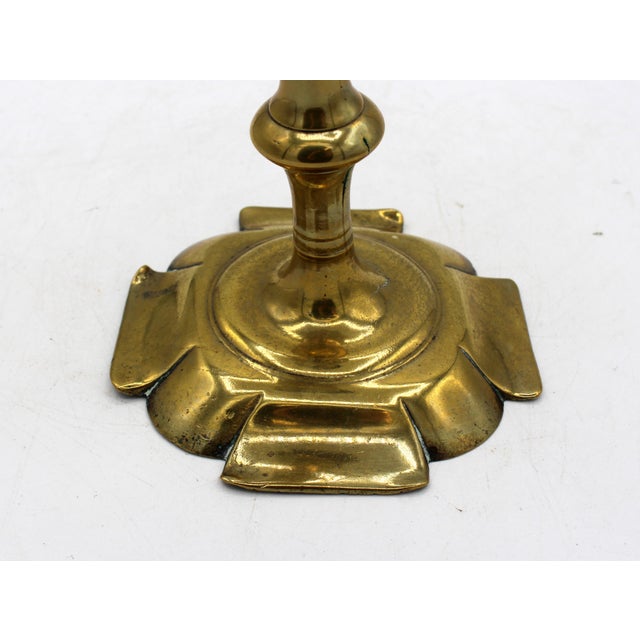 Pre-1740 English George II period brass candlestick. Octagonal petal base; the sides forming large, flat petals with...