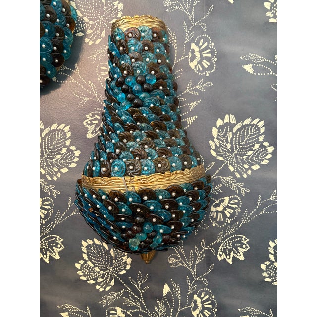 A stunning pair of vintage glass beaded sconces in turquoise and black. Top portion has a slight grape motif in round...