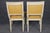An elegant and highly sophisticated set of eight French Empire style painted and gilt dining chairs, this exceptional...