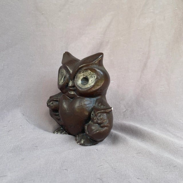 A unique owl carrying her two babies. This has a matte finish.