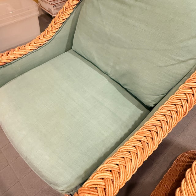 Pair of Round Back Rattan Lounge Chairs with Matching Ottomans A pair of classic round back, rattan lounge chairs with...