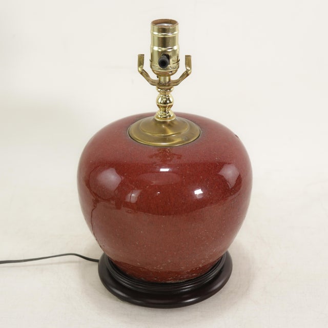 Elevate your space with this elegant vintage ceramic table lamp featuring a rich oxblood red glaze and timeless rounded...