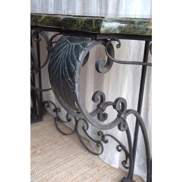 Large high -quality wrought iron console surmounted by a very thick splendid marble of 4 cm. Penpes in palmettes, acanthus...
