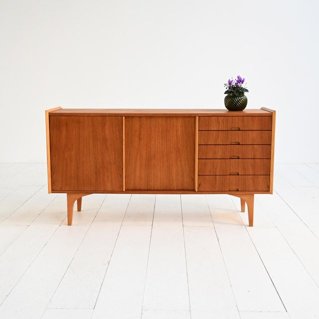 Teak veneer sideboard with a pine frame, sliding doors, and a side drawer. Scandinavian production, 1960s. Scandinavian...