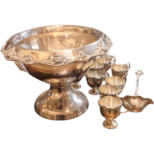 A Wallace 15"punch bowl set which includes the ladle and 9 matching cups. It stands 11 inches tall and 15 across