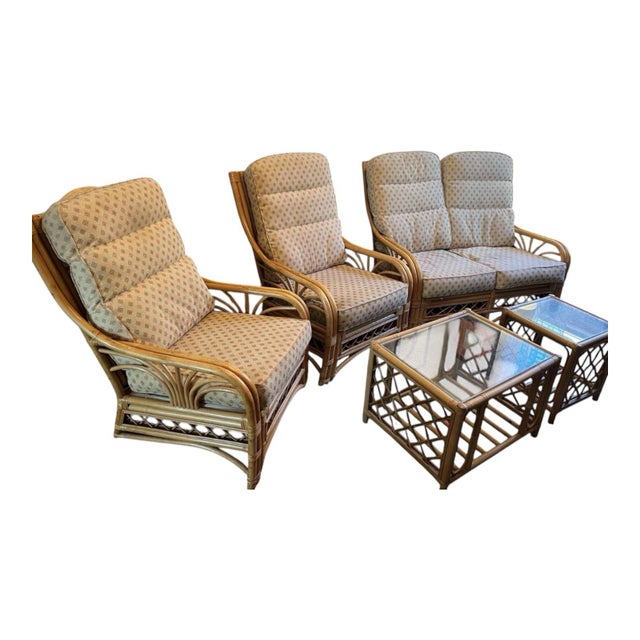 Elegant vintage rattan living room suite featuring dramatic fan-back silhouettes, sculptural bent-pole construction, and...