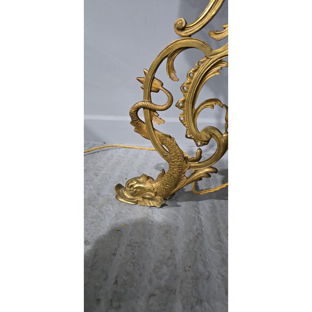 A superb brass engraved standard lamp standing on dolphin legs with a green onyx table, rewired and in excellent...