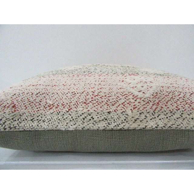 This is a pillow cover made from a vintage kilim rug. The piece was properly washed and ready to use. Pillow inserts not...