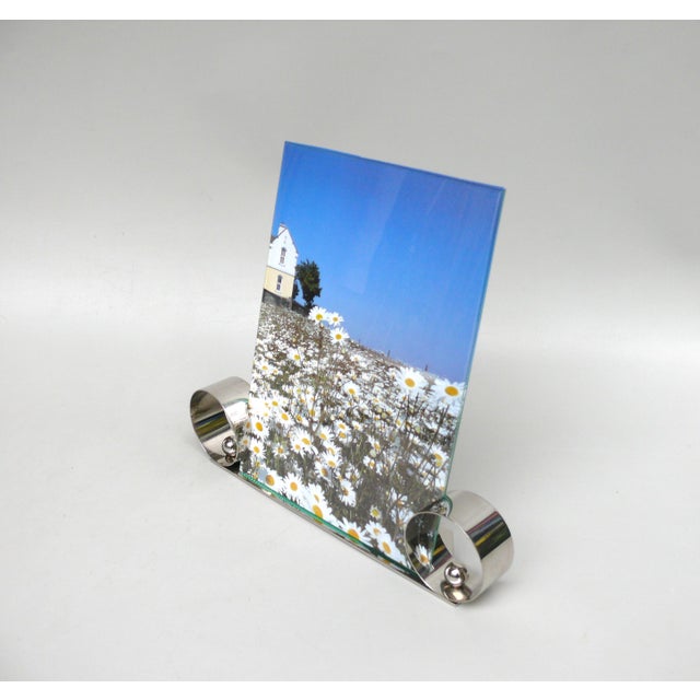 A large, elegant picture frame from the Art Deco period, characterized by its austere design, made in France. A sticker...