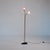 Floor lamp from the 1950s with a slim brass structure and two spherical opaline-glass diffusers. A black painted metal...