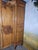 An elegant antique louis xv style wardrobe, crafted from solid fir, showcasing exquisite hand-carved details. The front is...