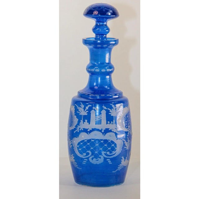 Antique blue crystal glass liquor decanter bottle which has been delicately etched. Mouth-blown crystal glass features a...