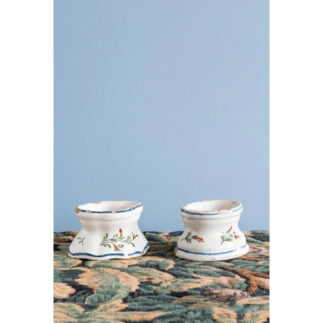 This pair of 18th-century French faience salt pigs from Rouen is decorated with elegant florals in red and green, enclosed...