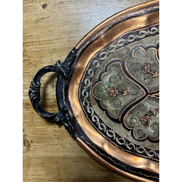 An antique copper tray of remarkable character, showcasing exceptional etched detail across its front. The intricate...