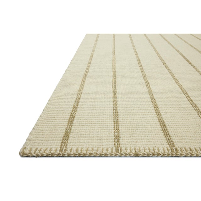 The Harlan Collection by Amber Lewis x Loloi is a classic striped flatweave area rug in the interior designer’s signature...