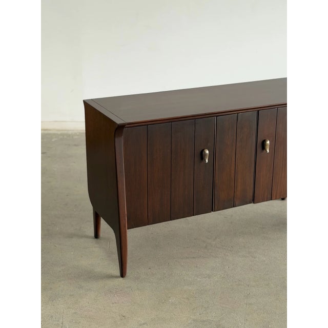 W48 D18 H28 Fully refinished to highlight the rich walnut wood grain. Features the original hardware, sculptural tapered...