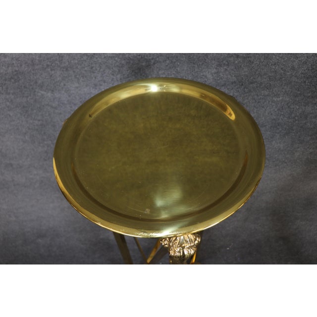 A striking and substantial pair of Regency-style brass pedestals or plant stands, distinguished by their elegant...
