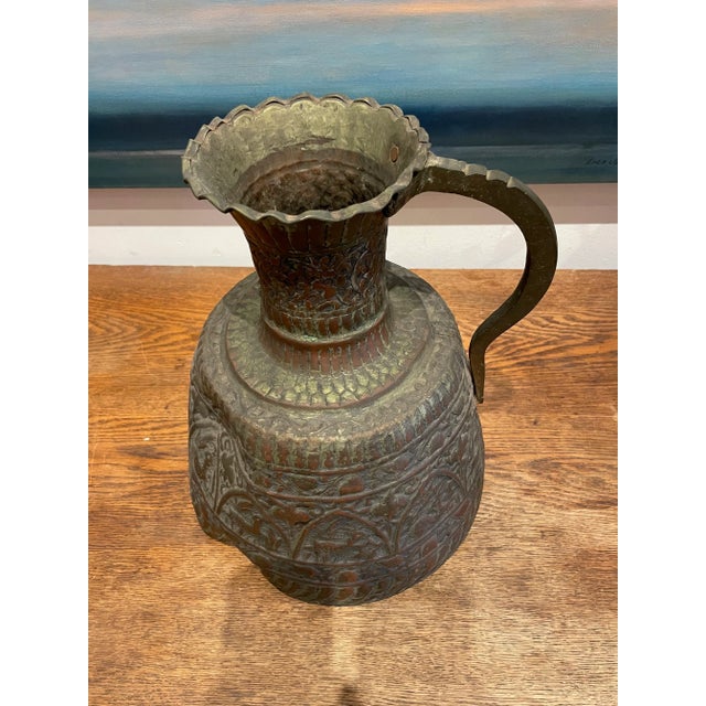 Antique Hammered Turkish Copper Pitcher. Featuring fantastic hand-hammered details of flora and fauna. Rustic texture and...