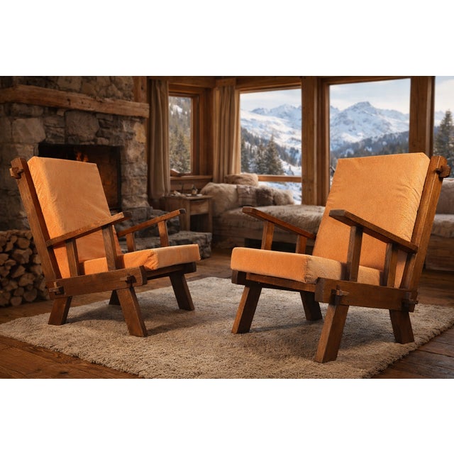 A stunning pair of Brutalist armchairs with a striking, sculptural design. The solid oak frame, with its clean lines and...